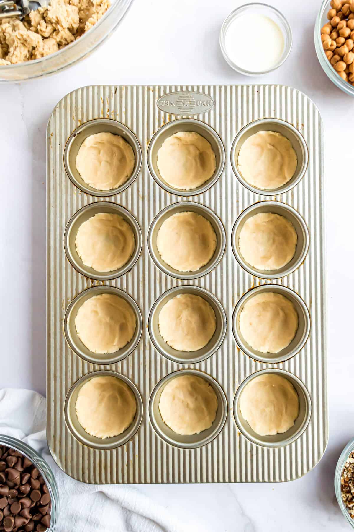 Muffin tin with cookie cups in it