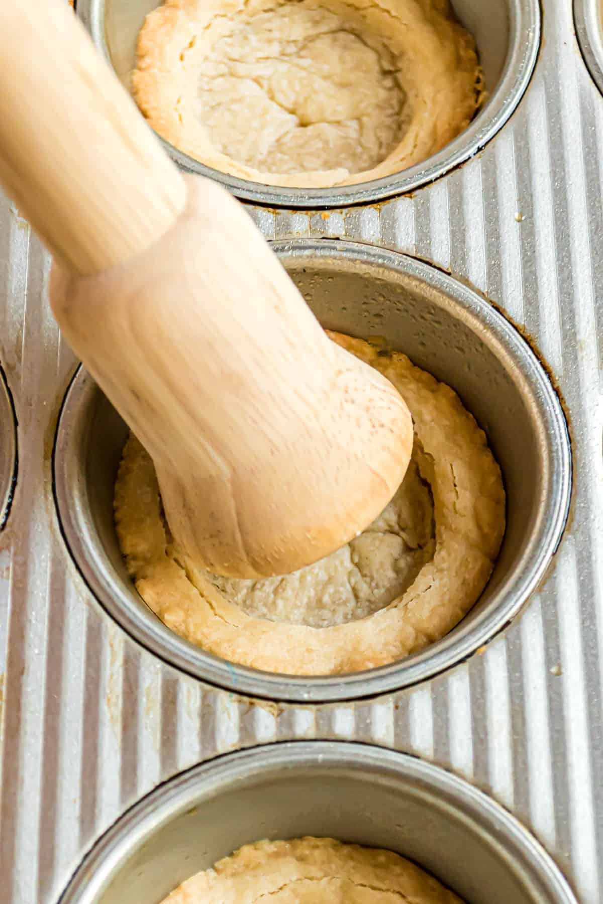 Pressing center of cookie cups down with tarte shaper