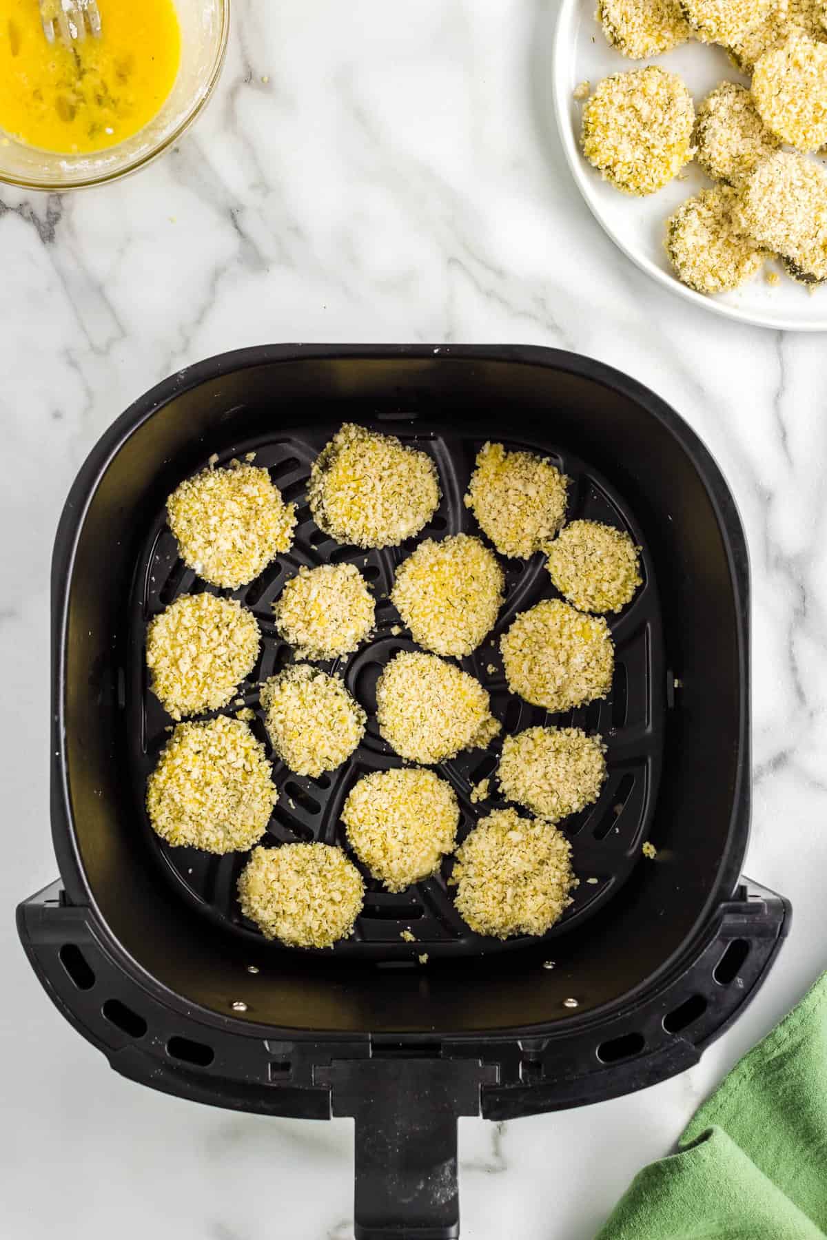 Cooking Coated Pickle Slices in Air Fryer Until Golden Brown for Pickle Chip Recipe