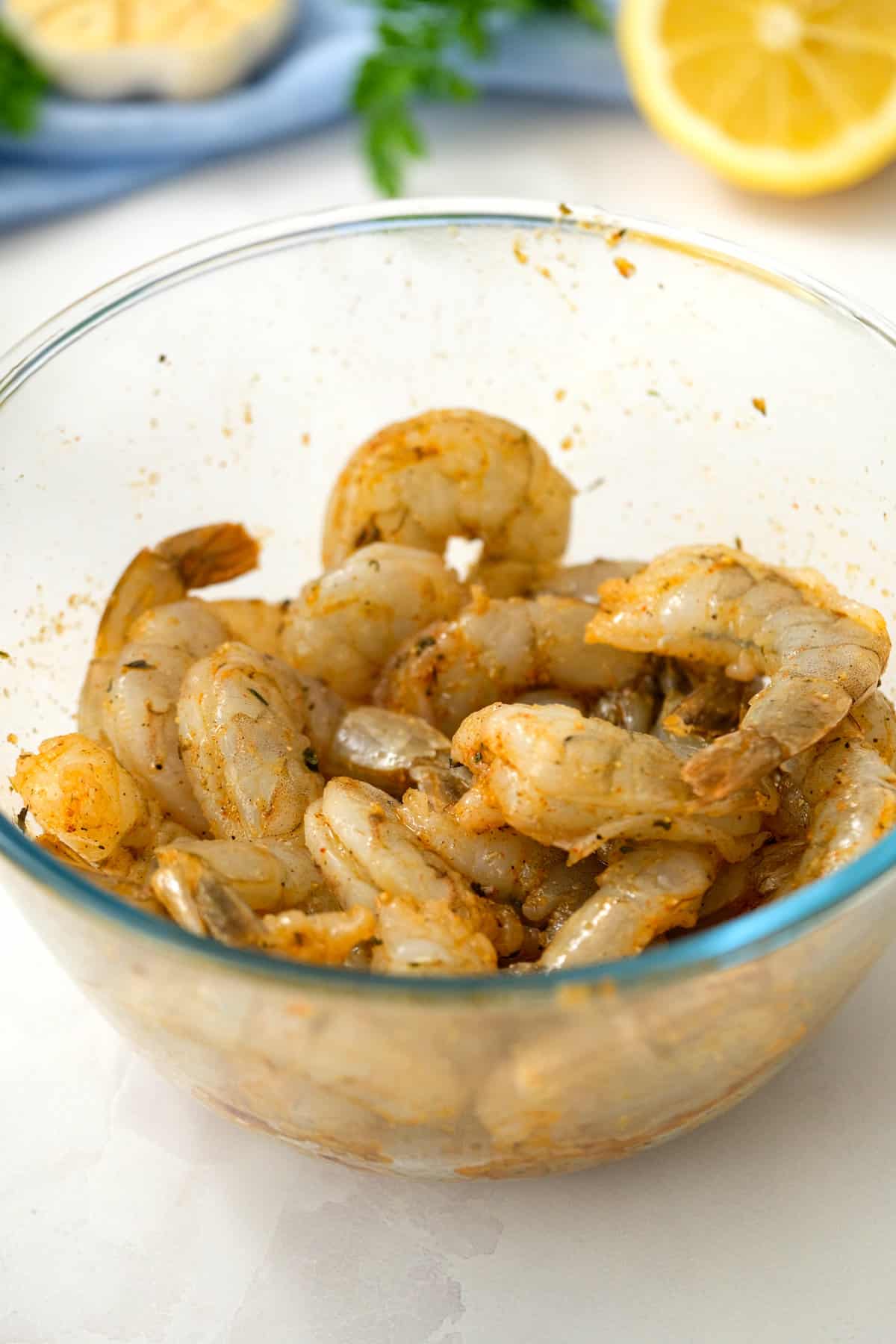 Glass bowl with seasoned raw shrimp