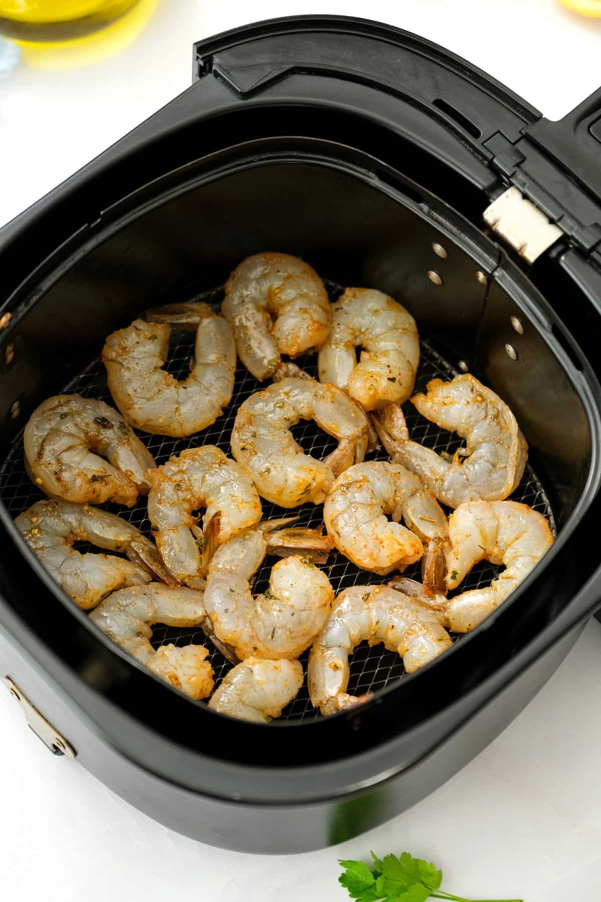 Air Fryer basket with raw shrimp