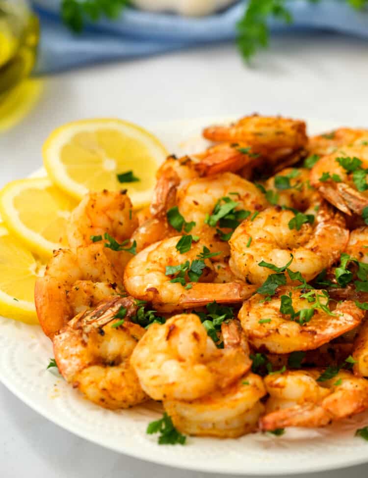 Air Fryer Shrimp on White plate with lemon slices