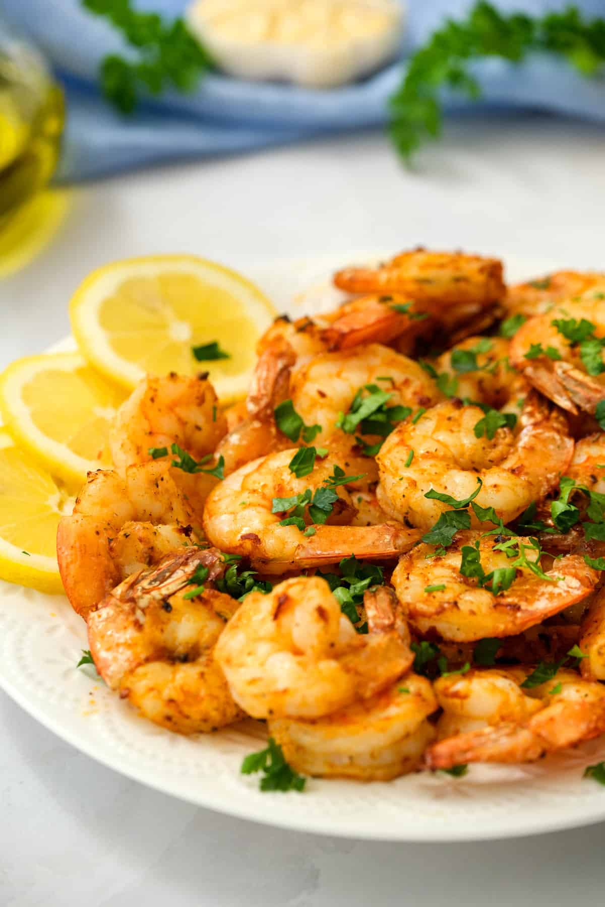 Air Fryer Shrimp on White plate with lemon slices