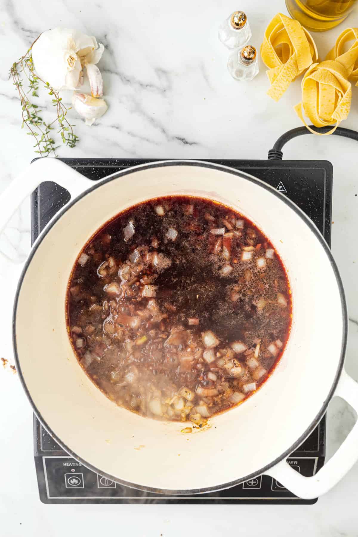 Deglazing Dutch Oven with Dry Red Wine for Beef Ragu Recipe