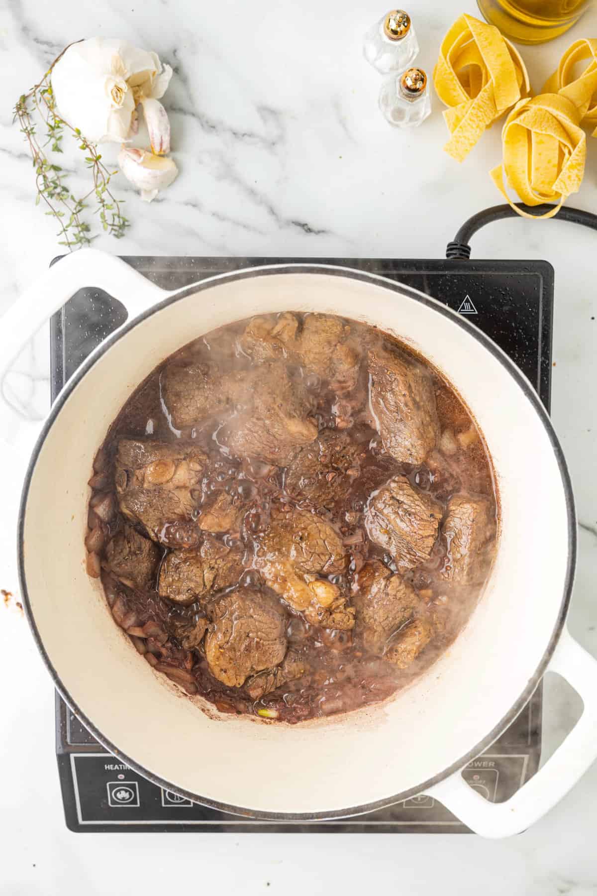 Adding Seared Beef to Sauted and Deglzed Onion & Garlic Mixture for Beef Ragu Pasta Sauce