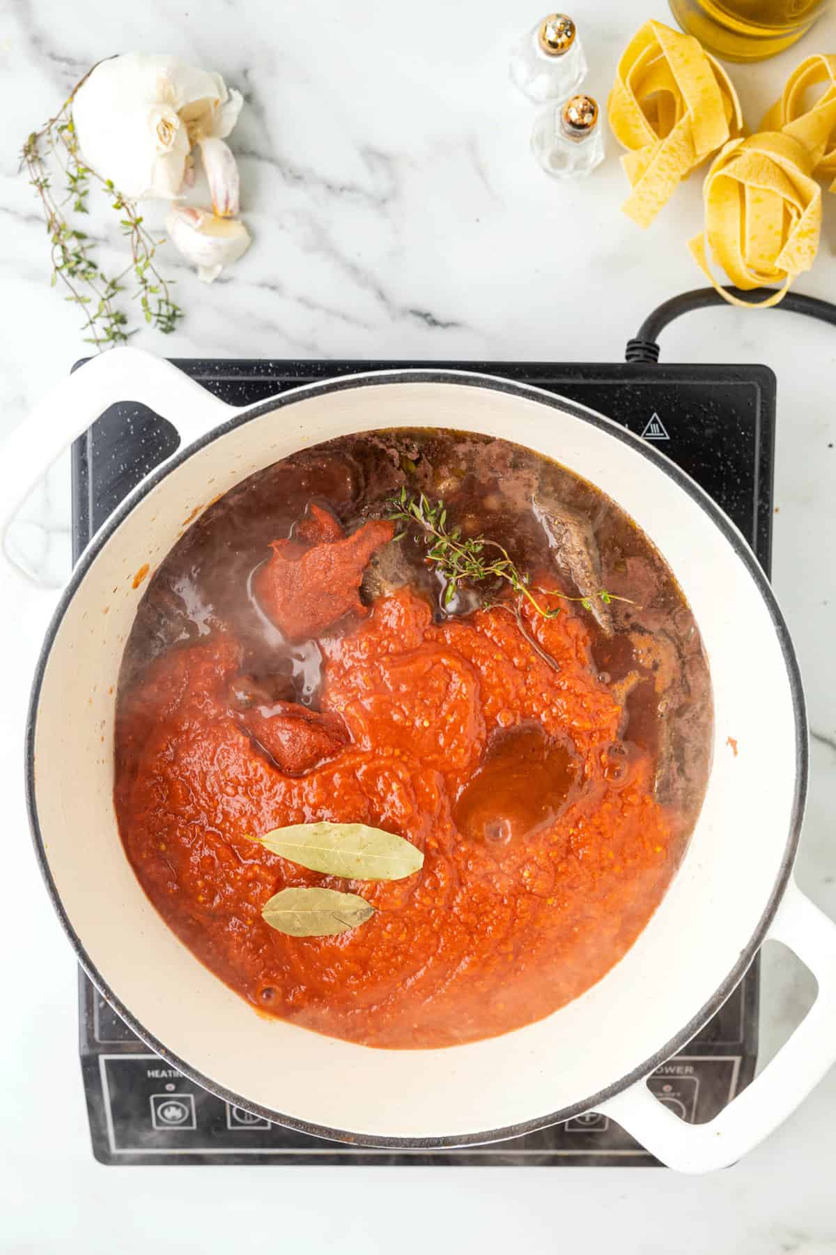 Adding Bay Leaves & Thyme to Pot for Beef Ragu Pasta Sauce