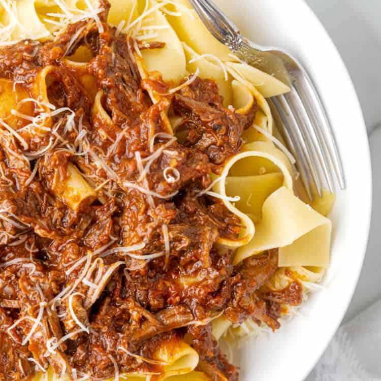 Ragu Pasta with Pappardelle and Beef in Bowl with Grated Parmesan