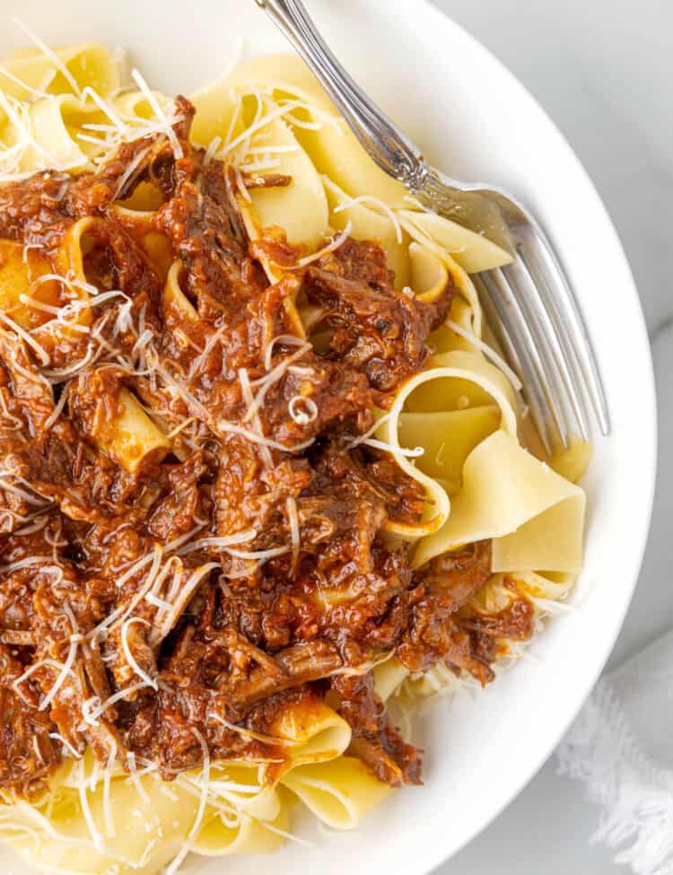 Ragu Pasta with Pappardelle and Beef in Bowl with Grated Parmesan