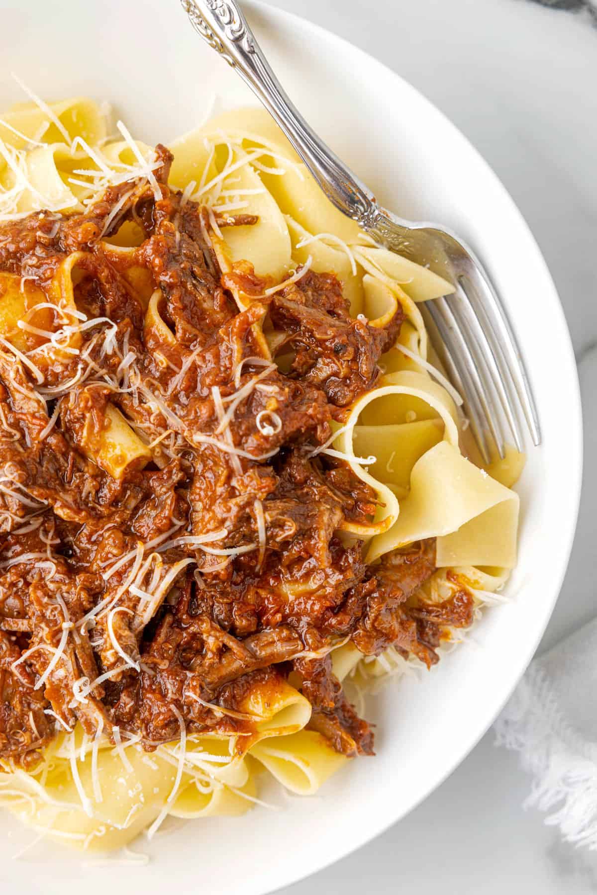 Ragu Pasta with Pappardelle and Beef in Bowl with Grated Parmesan