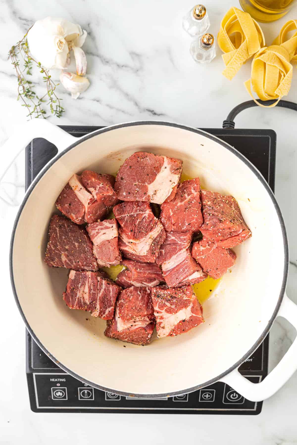 Searing All Side of Seasoned Beef in Dutch Oven