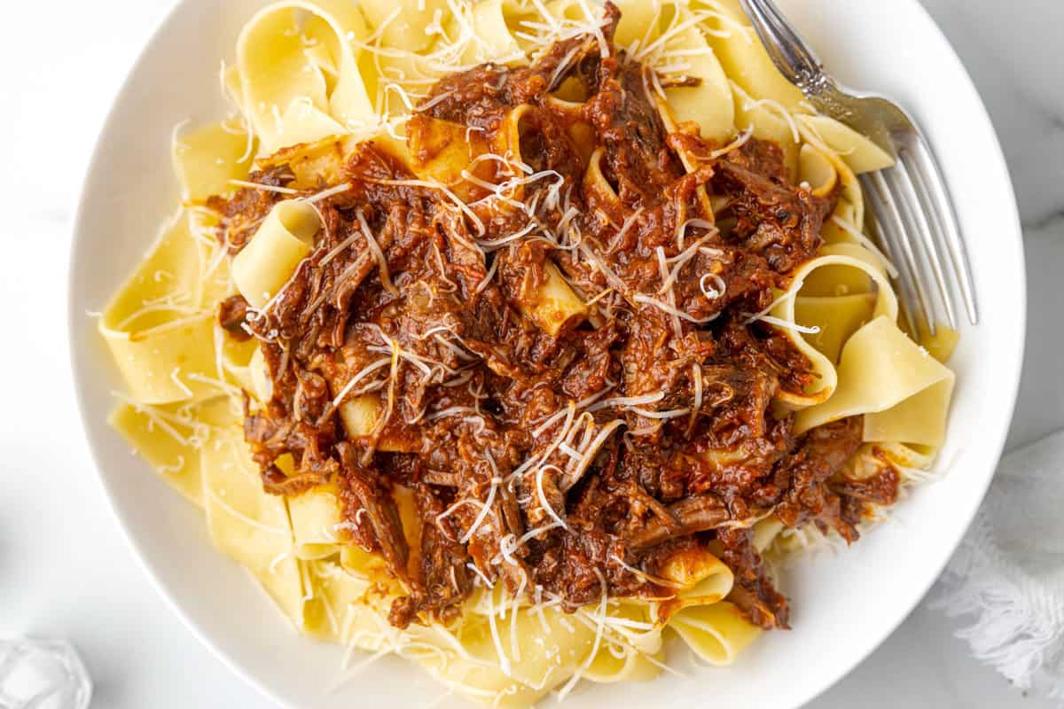 Beef Ragu Recipe in Bowl with Shredded Parmesan