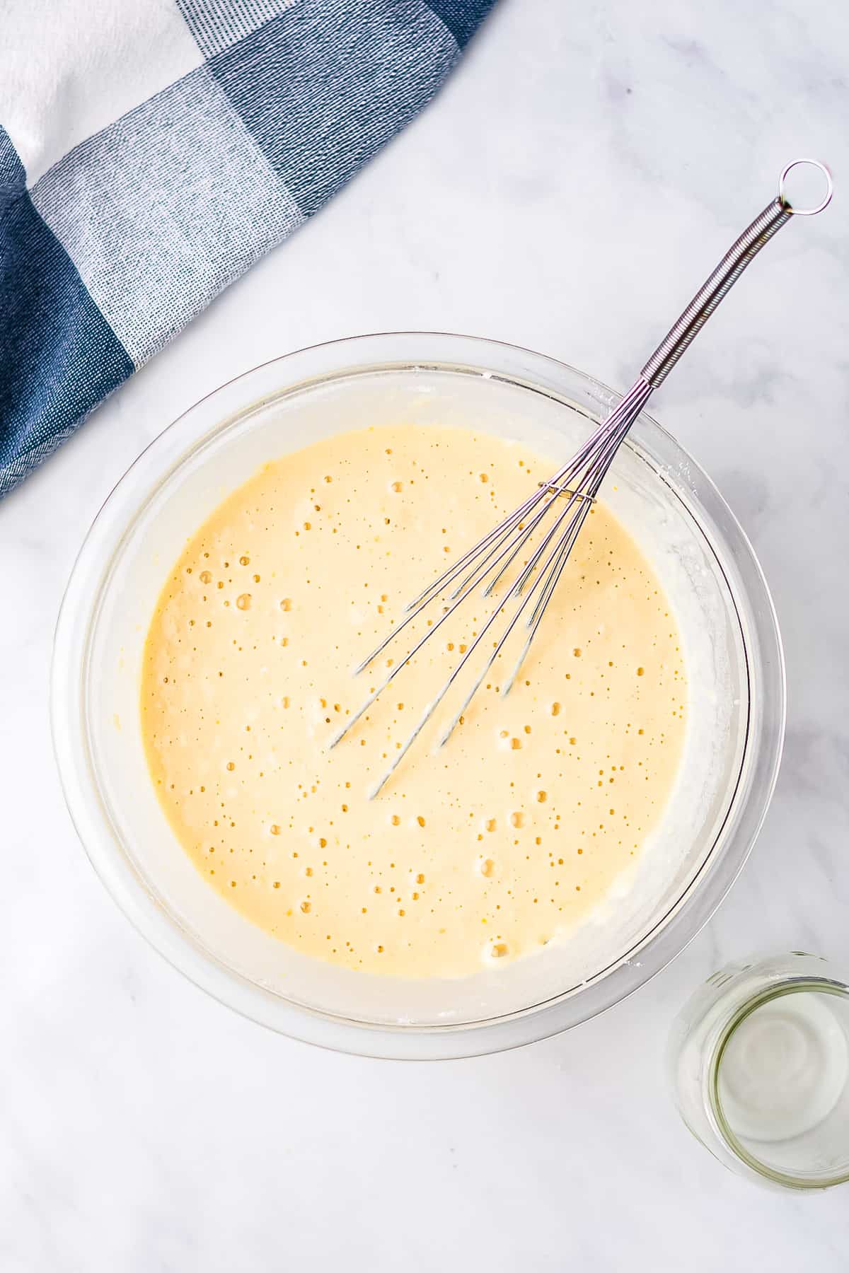 Glass bowl with buttermilk pancake batter mixed in it