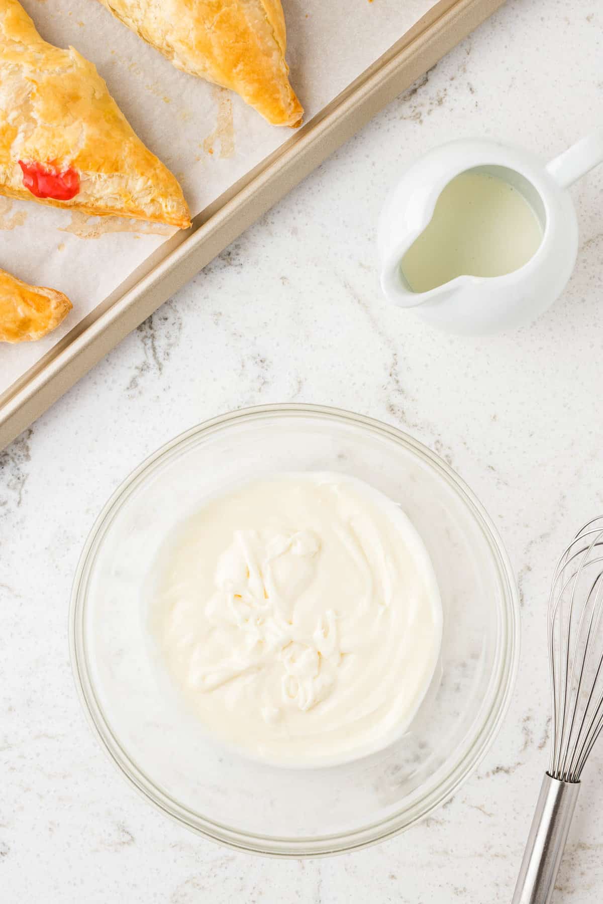 Frosting in Clear Bowl for Homemade Cherry Turnovers