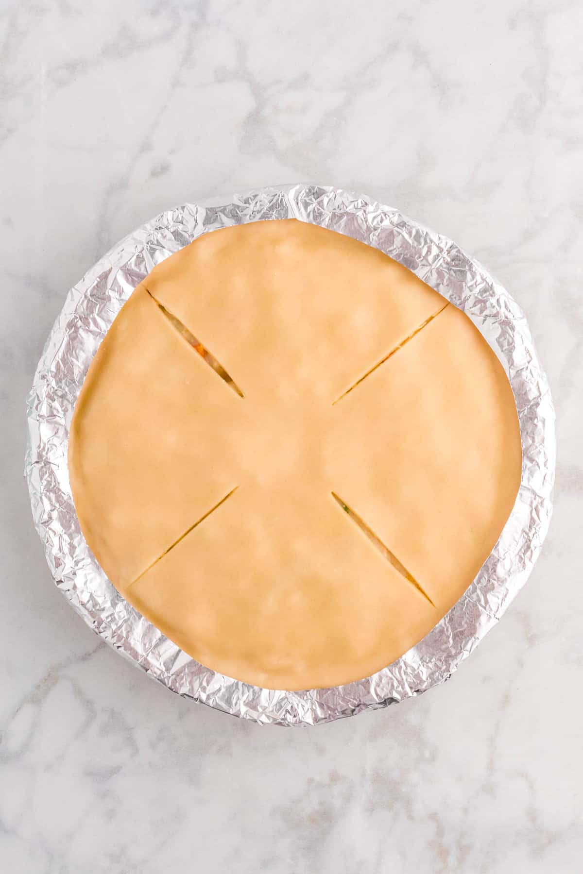 Overhead Image of Oven-Ready Chicken Pot Pie with Tin Foil Covering Crust Edge