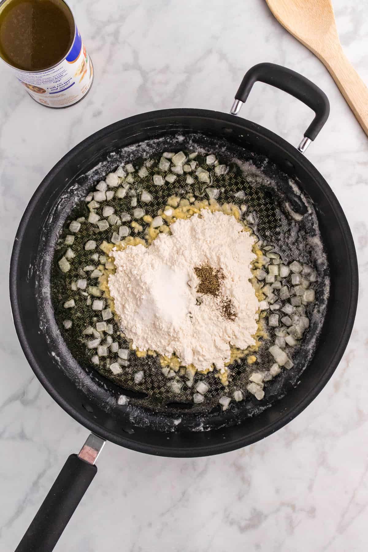 Skillet with butter, onions, and flour in it