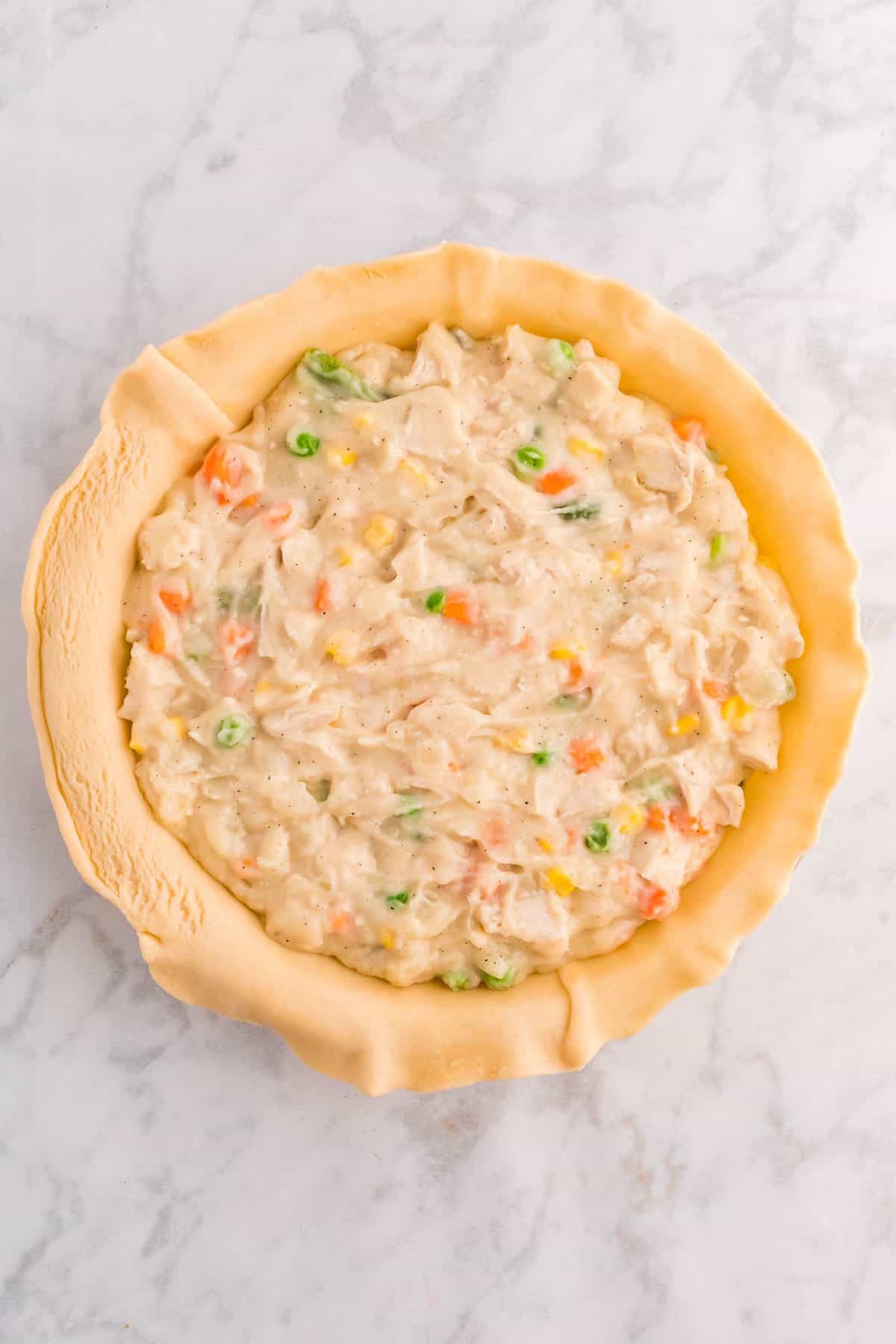 Chicken Pot Pie Filling in Crust Before Baking