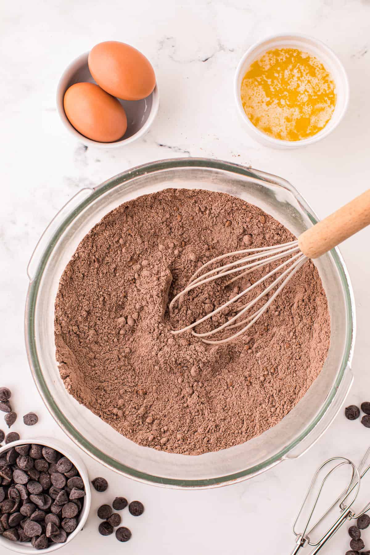 Mixing Cake Mix Chocolate Cookies in Clear Bowl with Whisk