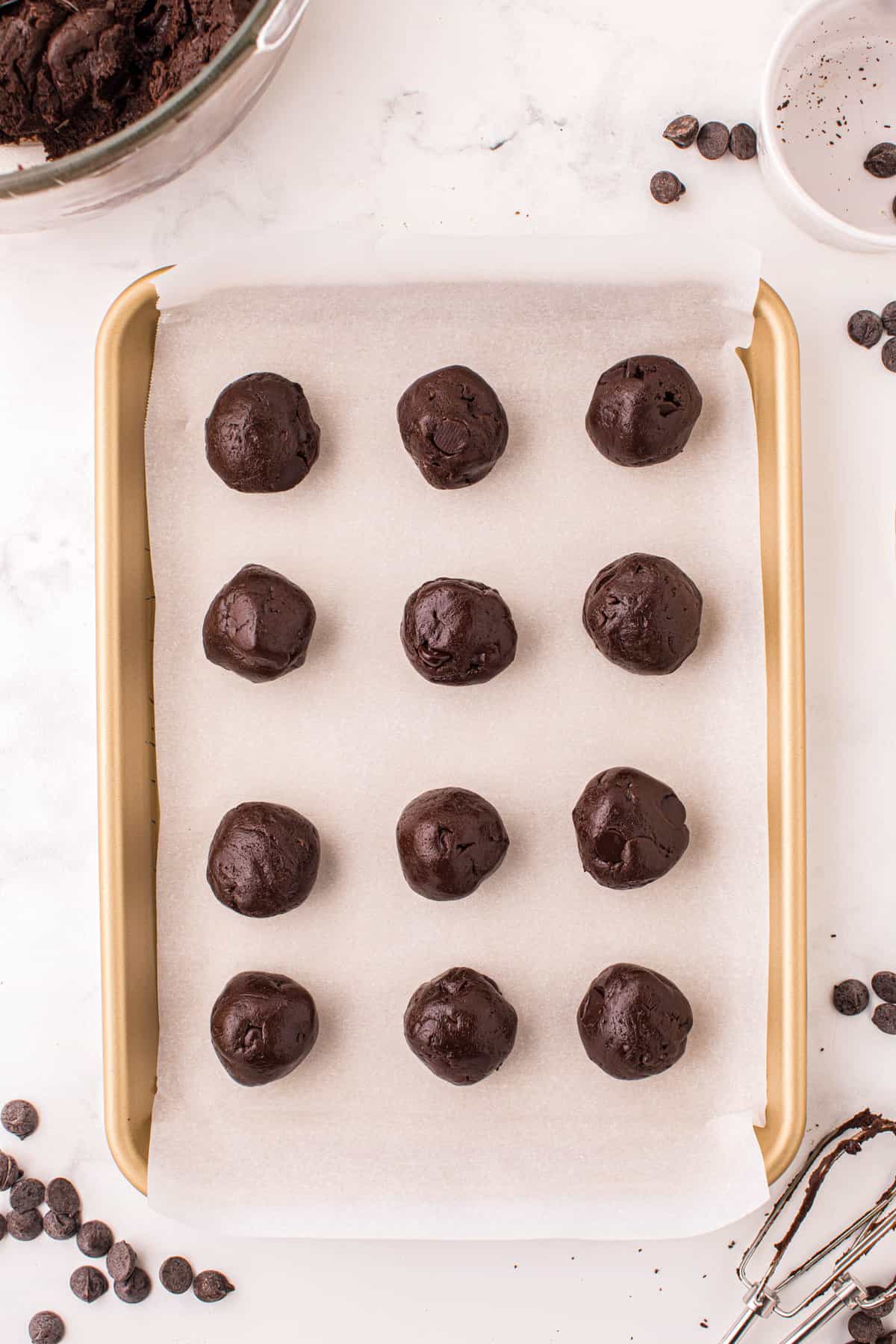 Cake Mix Chocolate Cookies Rolled into Balls on Parchment Lined Cookie Sheet