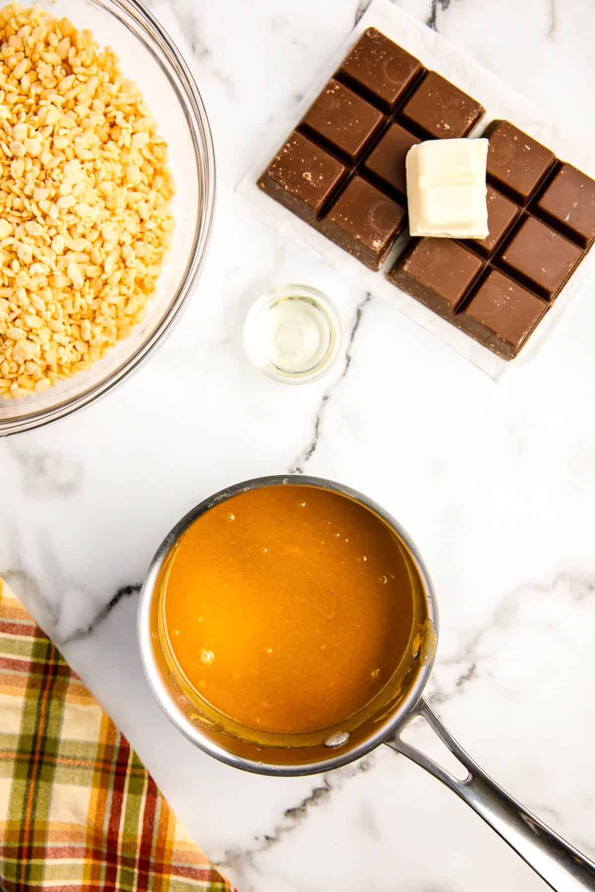 Peanut butter and vanilla in saucepan for football scotcheroos