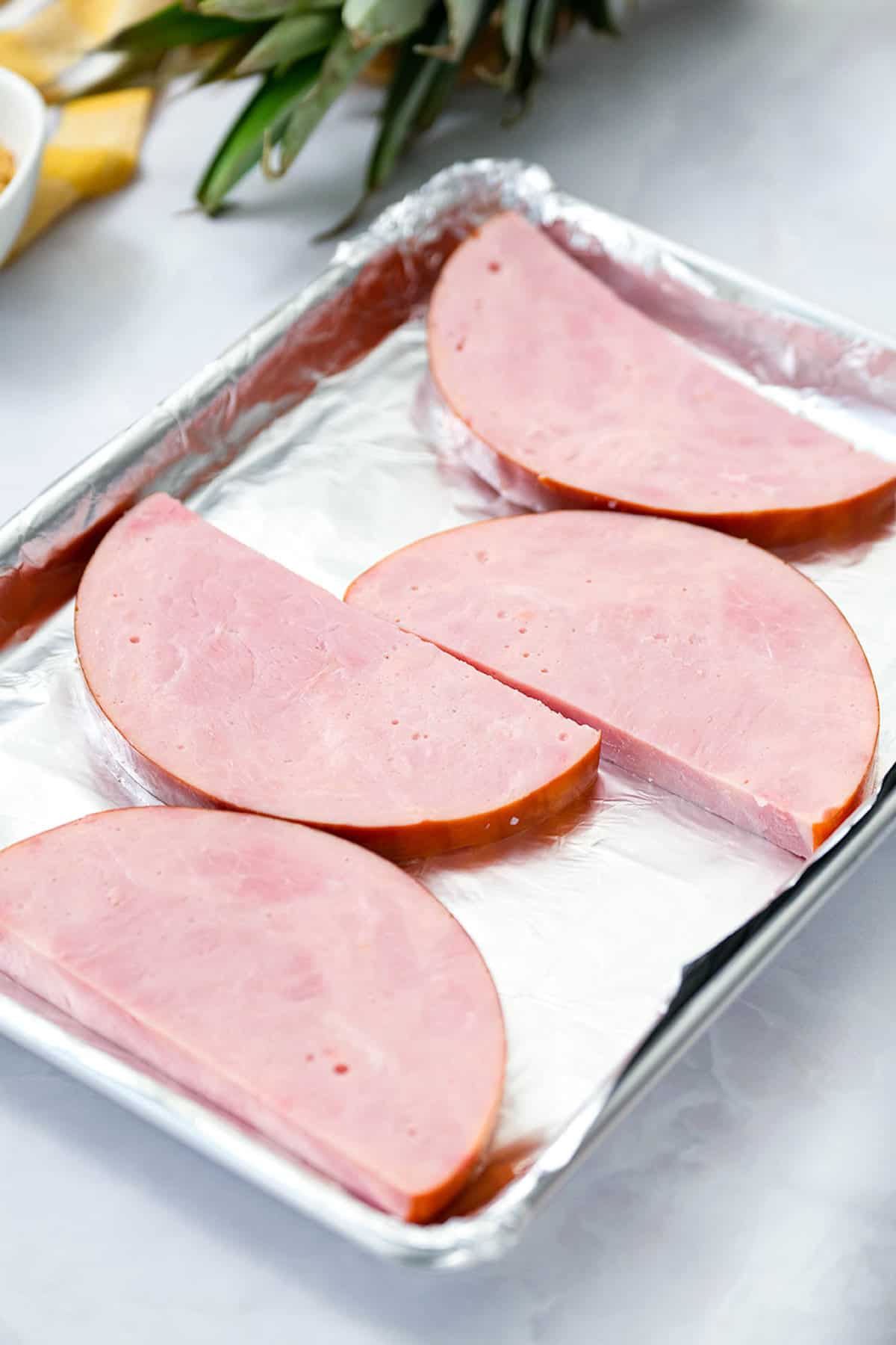 Ham Steaks on Tinfoil Lined Baking Sheet