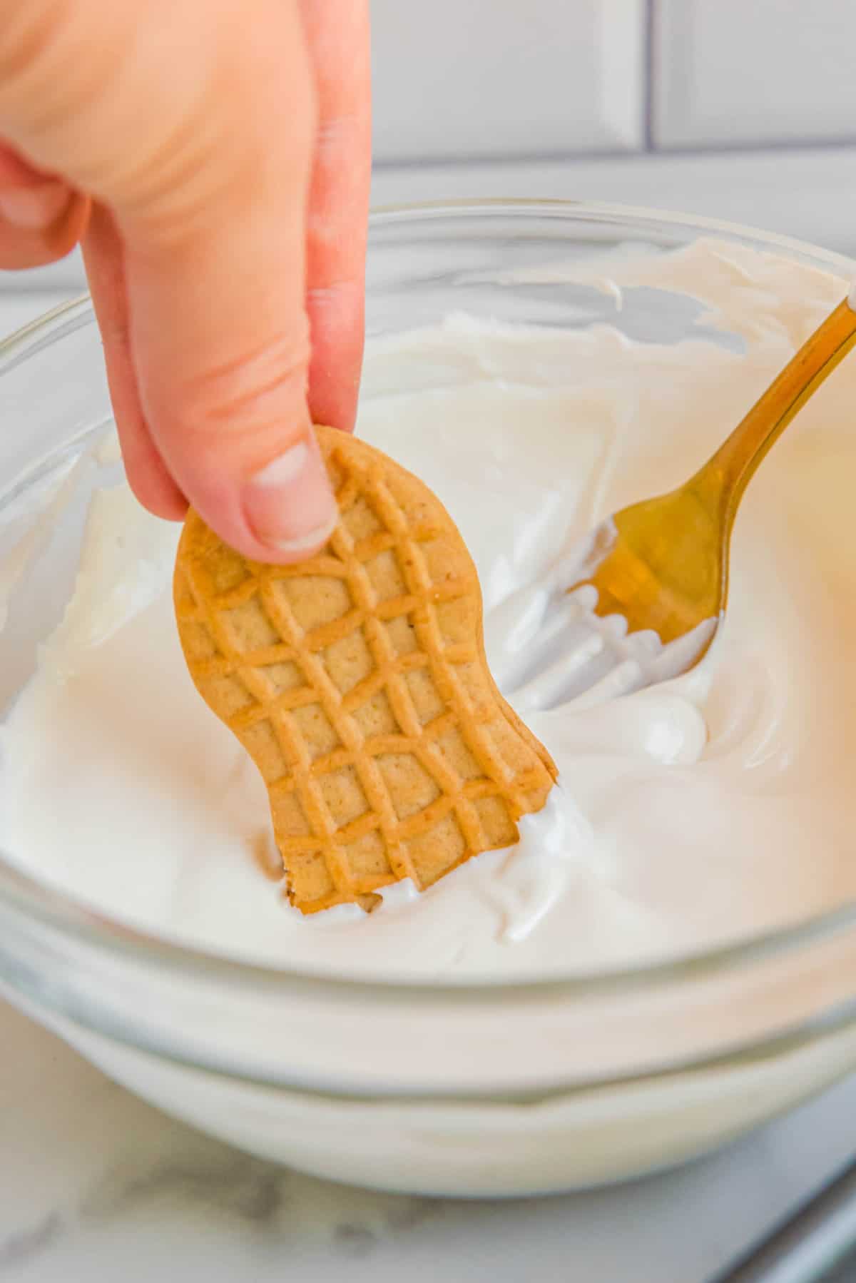 Dipping Nutter Butter Cookie in White Candy Melt