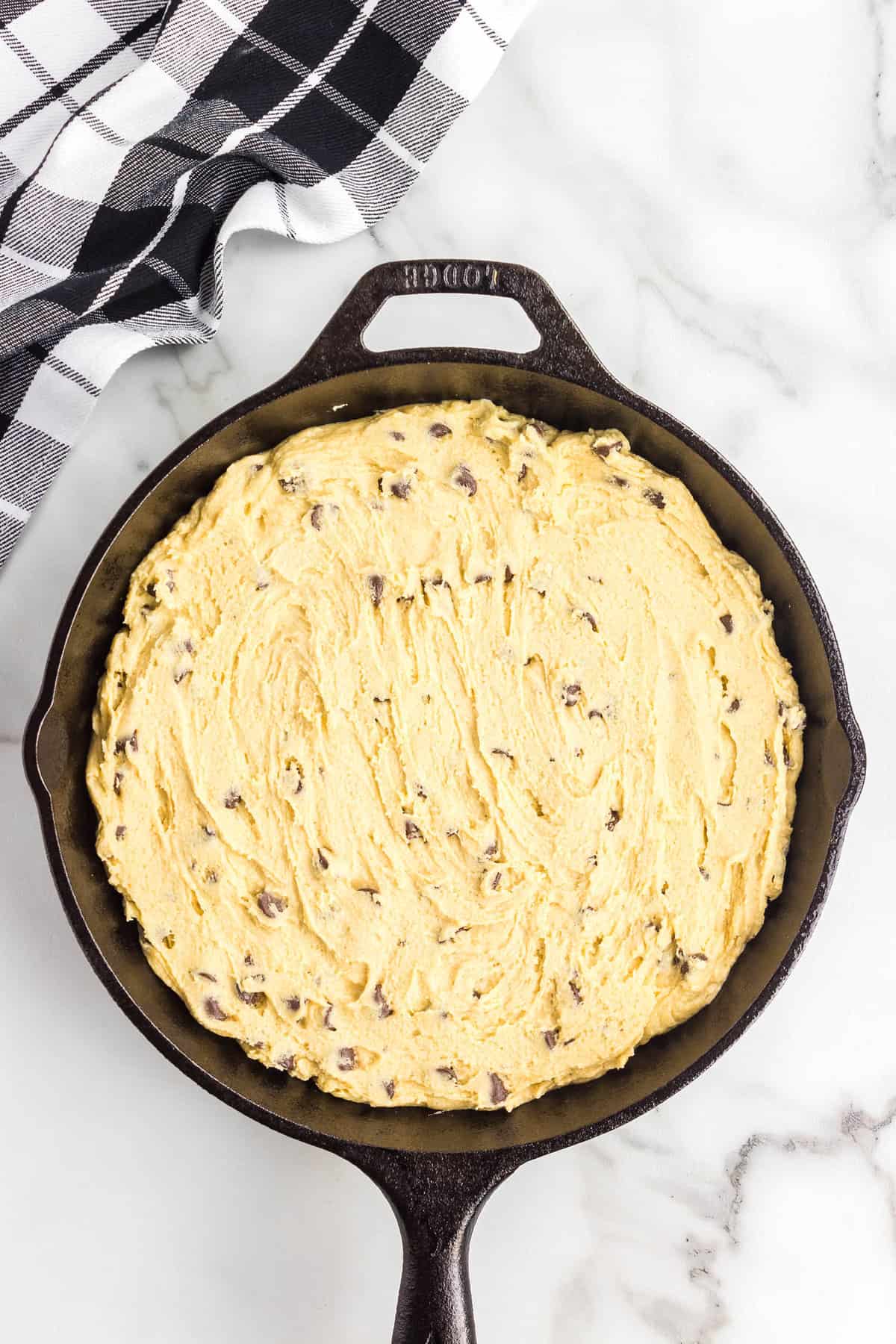 Spreading Cookie Recipe into Prepared Skillet