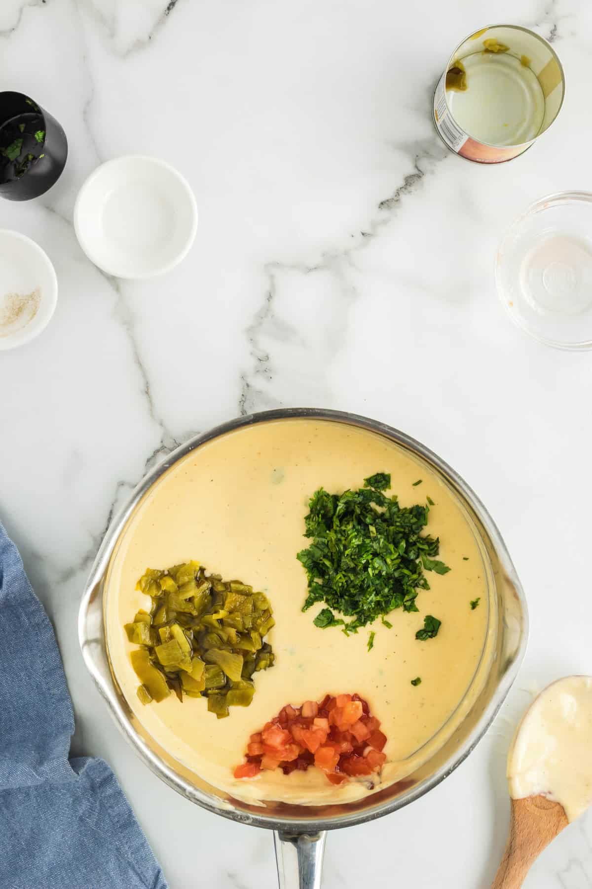 Stirring in Tomato, Green Chiles, and Cilantro