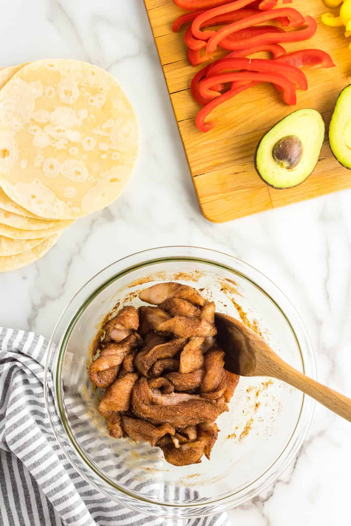 Combining Chicken with Oil and Fajita Seasoning for Air Fryer Chicken Fajitas