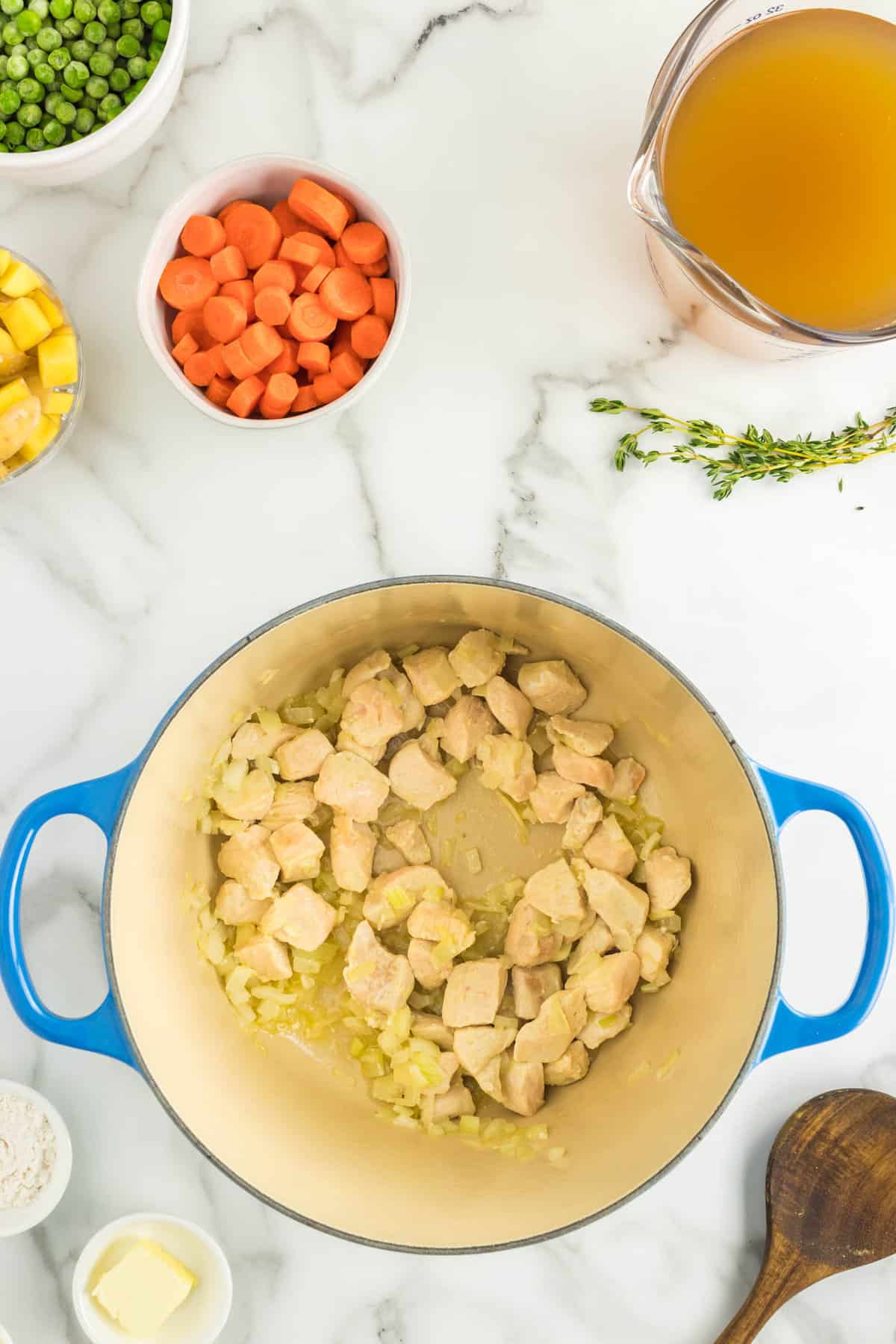 Adding Cubed Chicken and Olive Oil to Large Pot for Chicken Pot Pie Soup Recipe