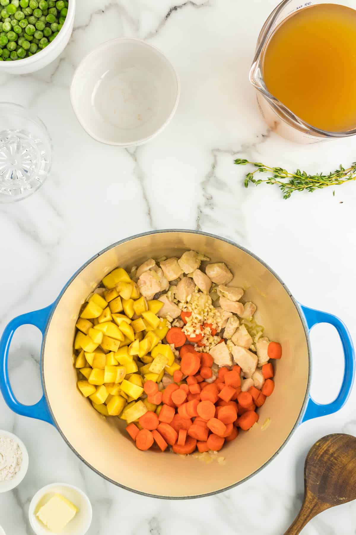 Adding Carrots, Garlic, and Yukon Gold Potatoes to Chicken Mixture for Chicken Pot Pie Soup Recipe