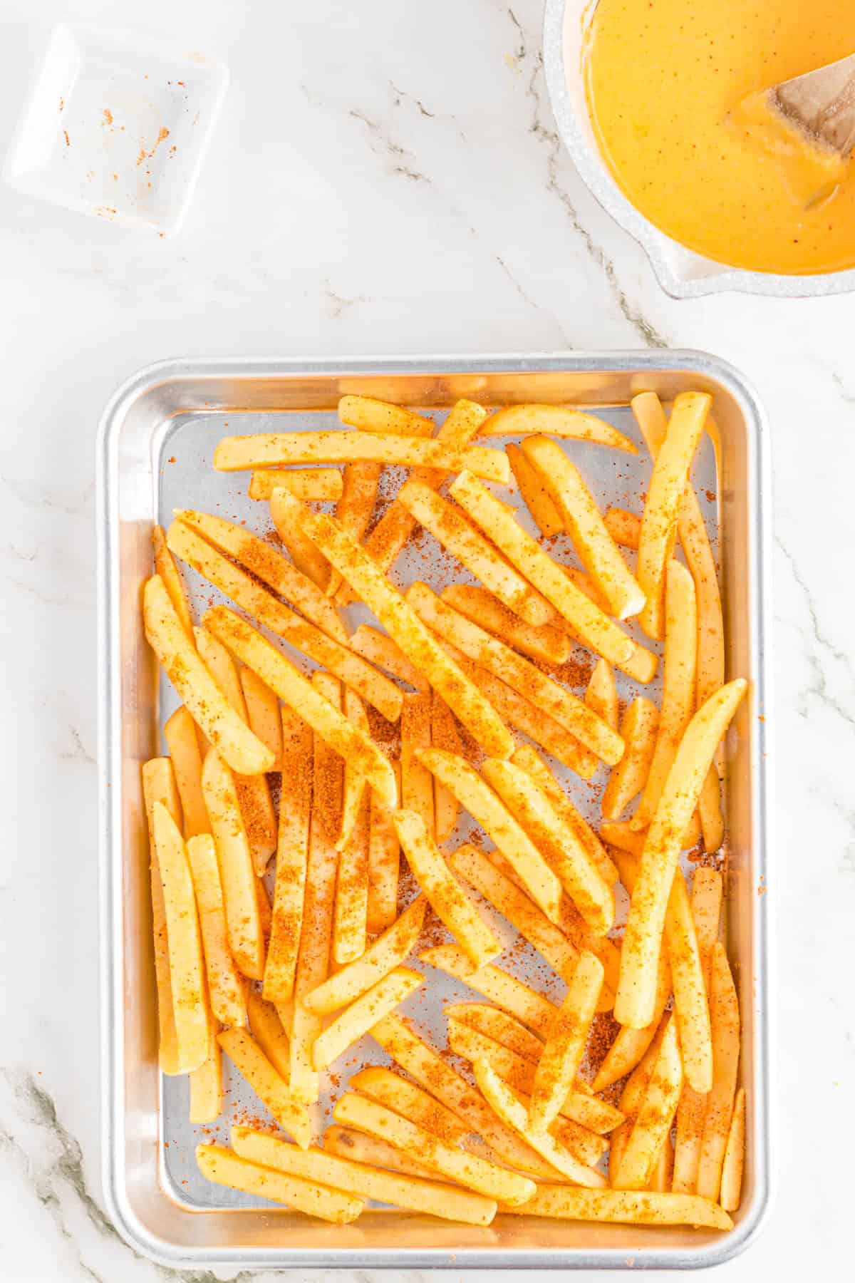 Nacho Fries Recipe with Taco Seasoned Fries on Baking Sheet