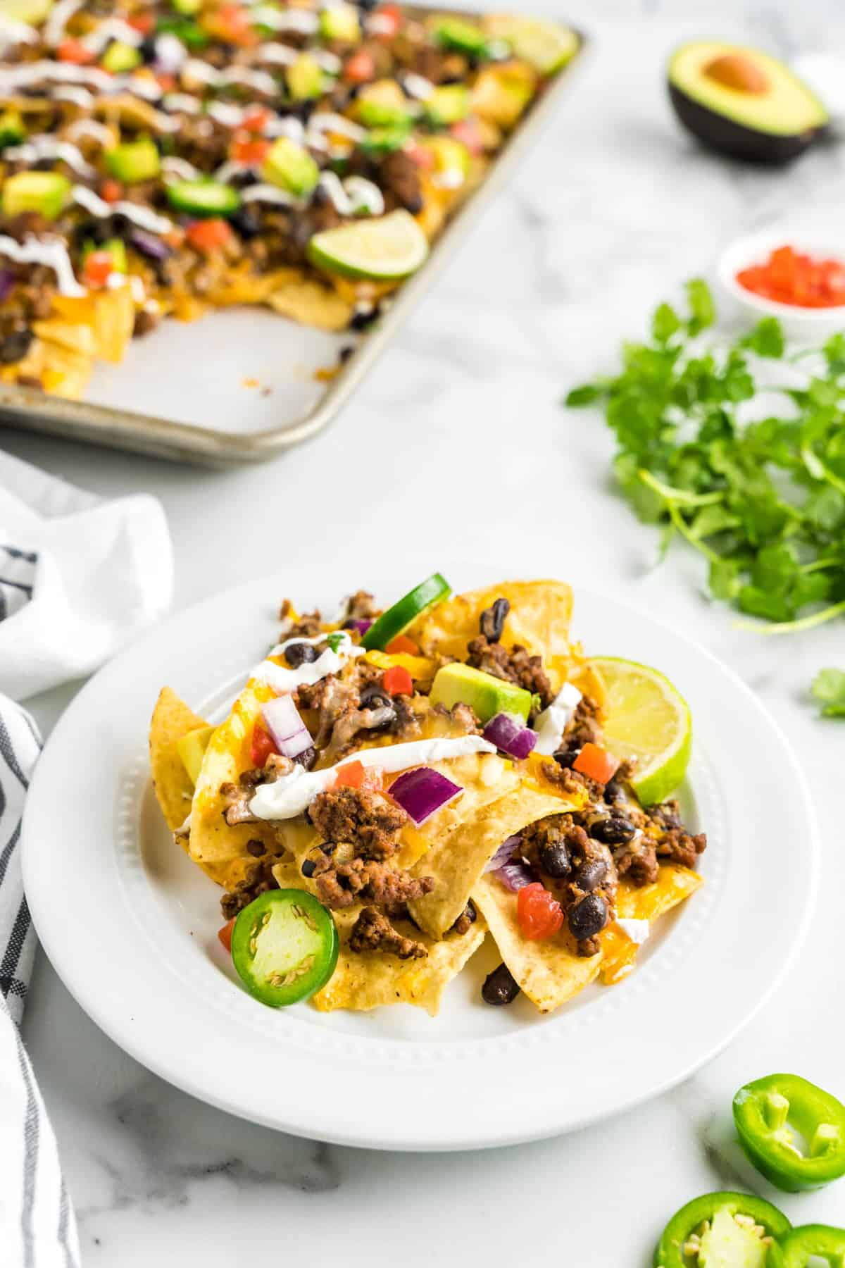 Loaded Nachos on Plate with Fixings Ready to Enjoy