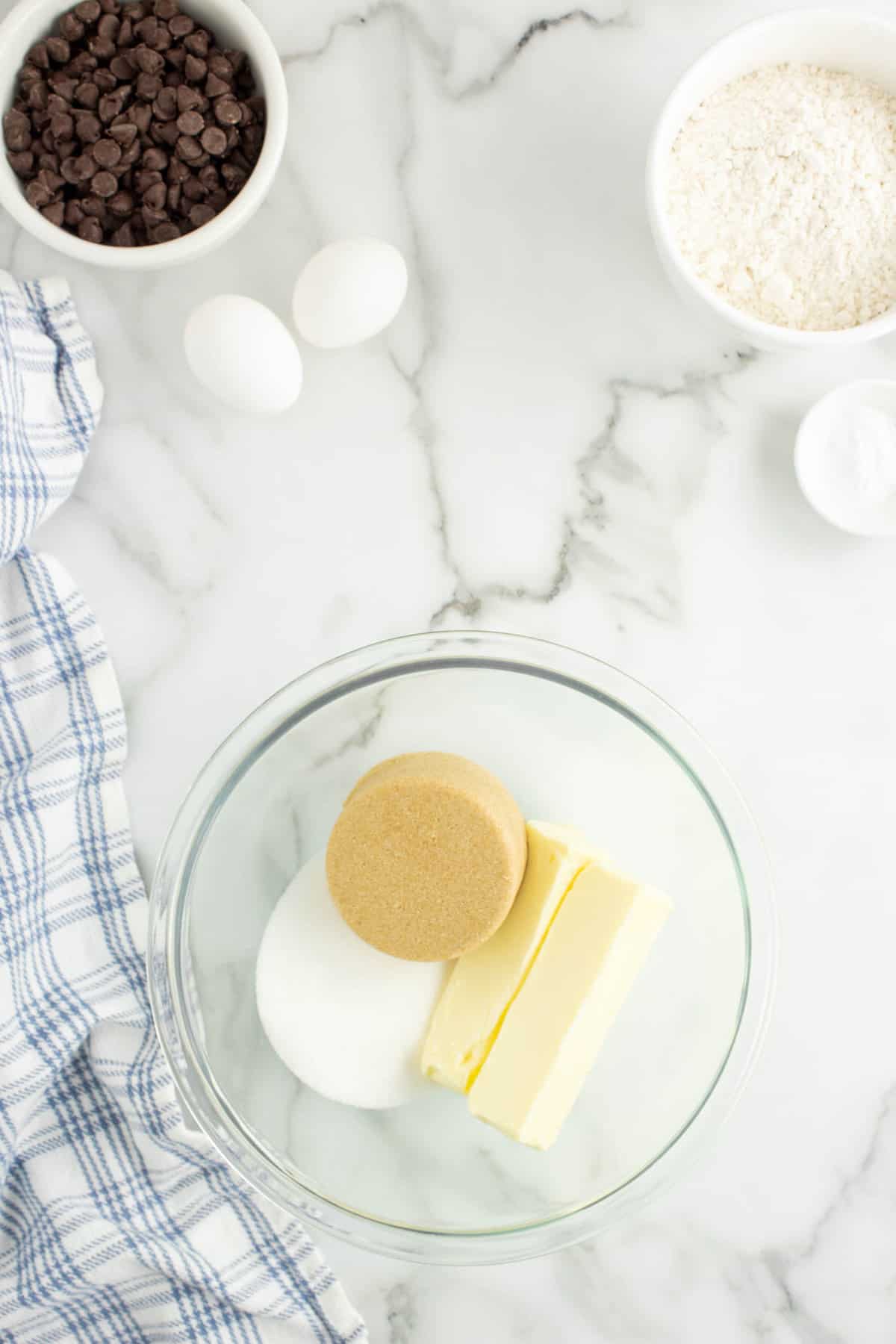 Butter and Sugars in Glass Mixing Bowl for Chewy Oatmeal Chocolate Chip Cookies