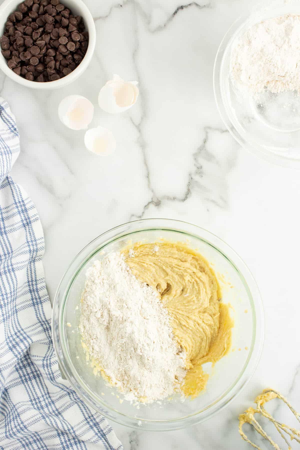 Adding in Flour to Cookie Base in Mixing Bowl for Oatmeal Chocolate Chip Cookie Recipe