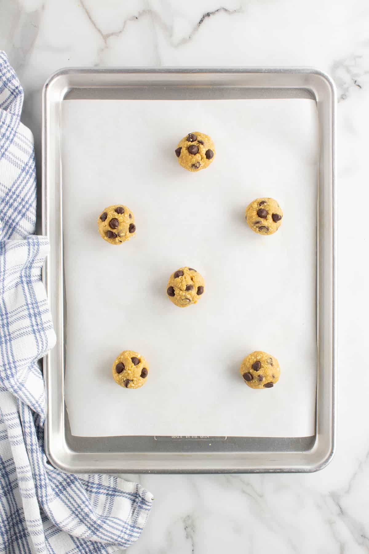 Formed Dough into Balls on Parchment Paper Lined Baking Sheet for Oatmeal Chocoloate Chip Cookie Recipe