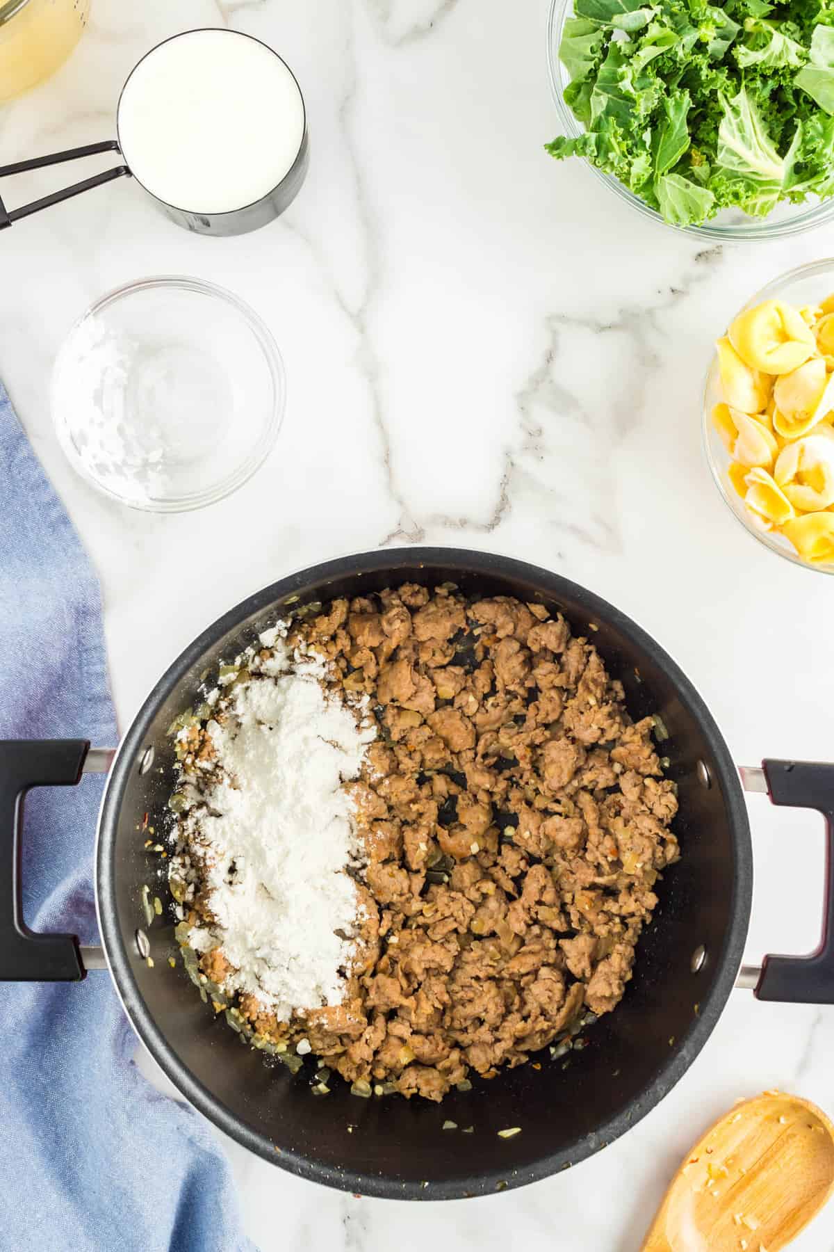 Adding Ingredients to Creamy Italian Sausage Tortellini Soup