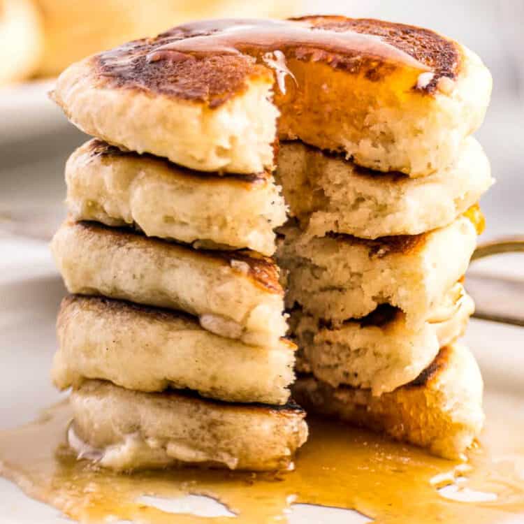 Stack of mini pancakes with a bite out of them.