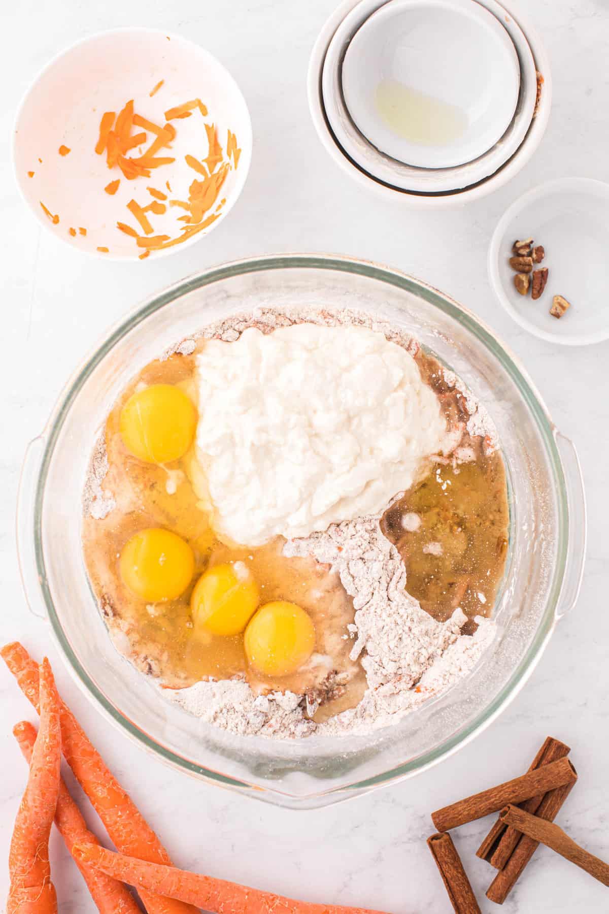 Adding Eggs, Greek Yogurt, and Spices to Carrot Bundt Cake Recipe