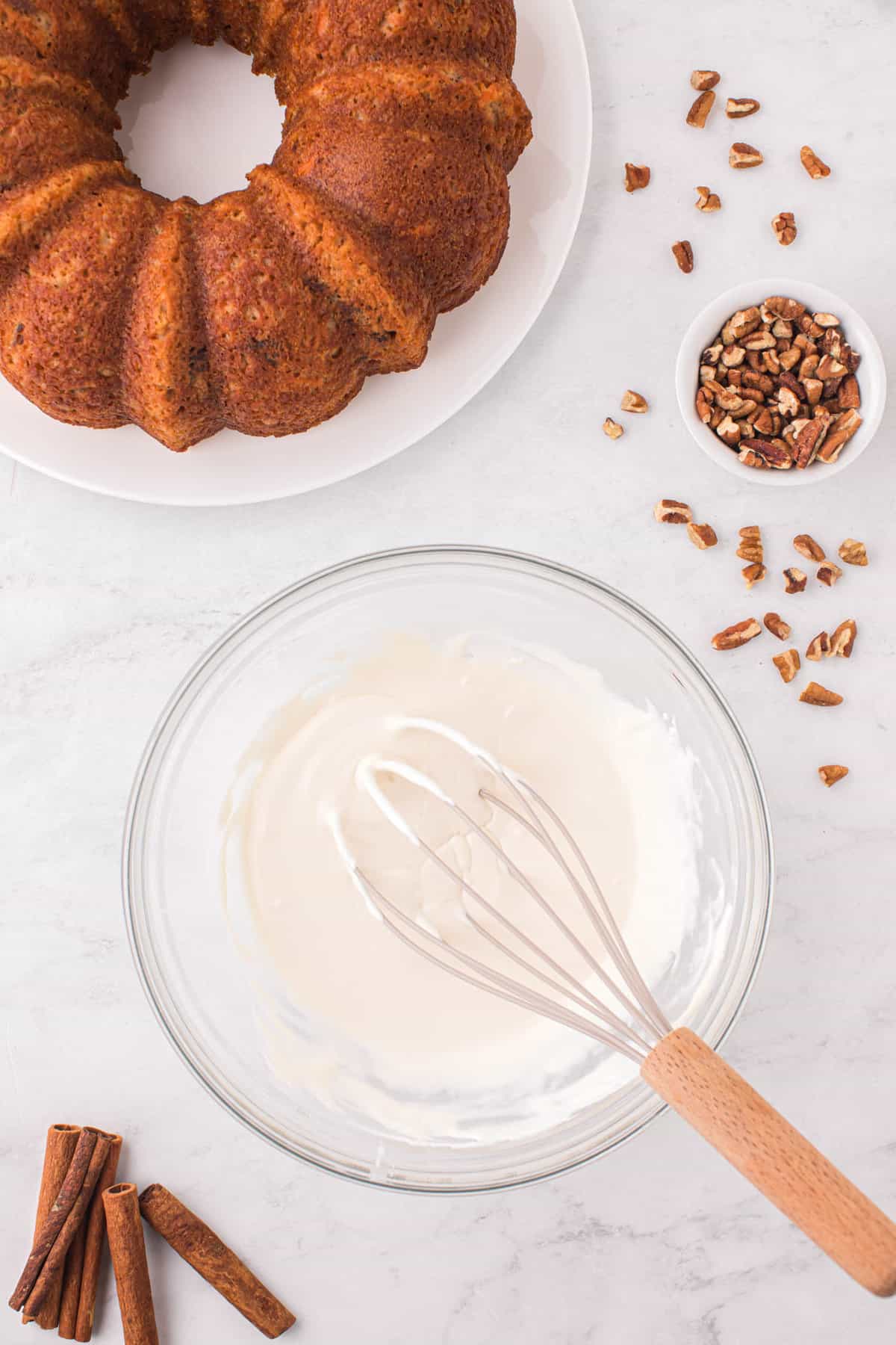 Whisking Together Heavy Cream and Prepared Cream Cheese Frosting for Carrot Bundt Cake Reipe