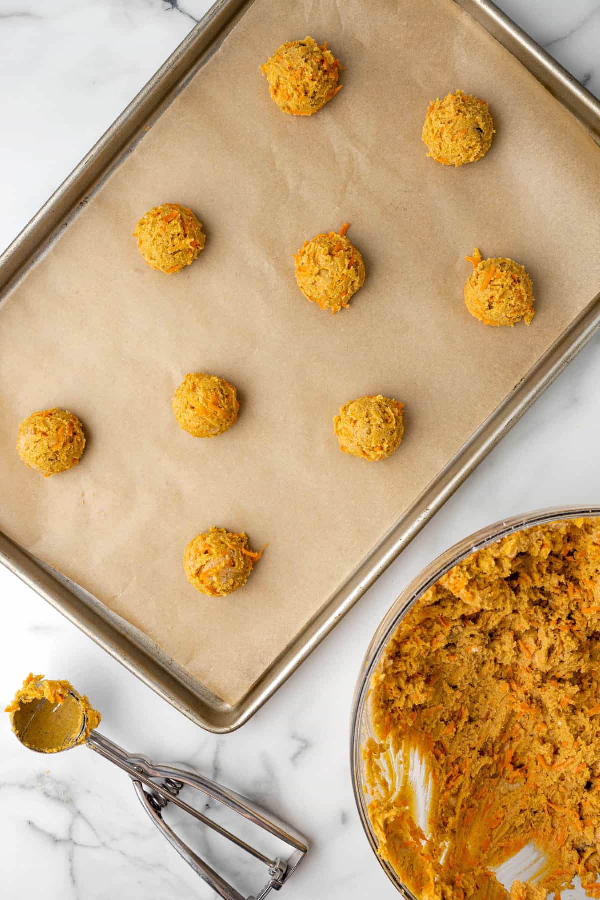 Carrot Cake Cookie Batter Formed into Balls on Cookie Sheet
