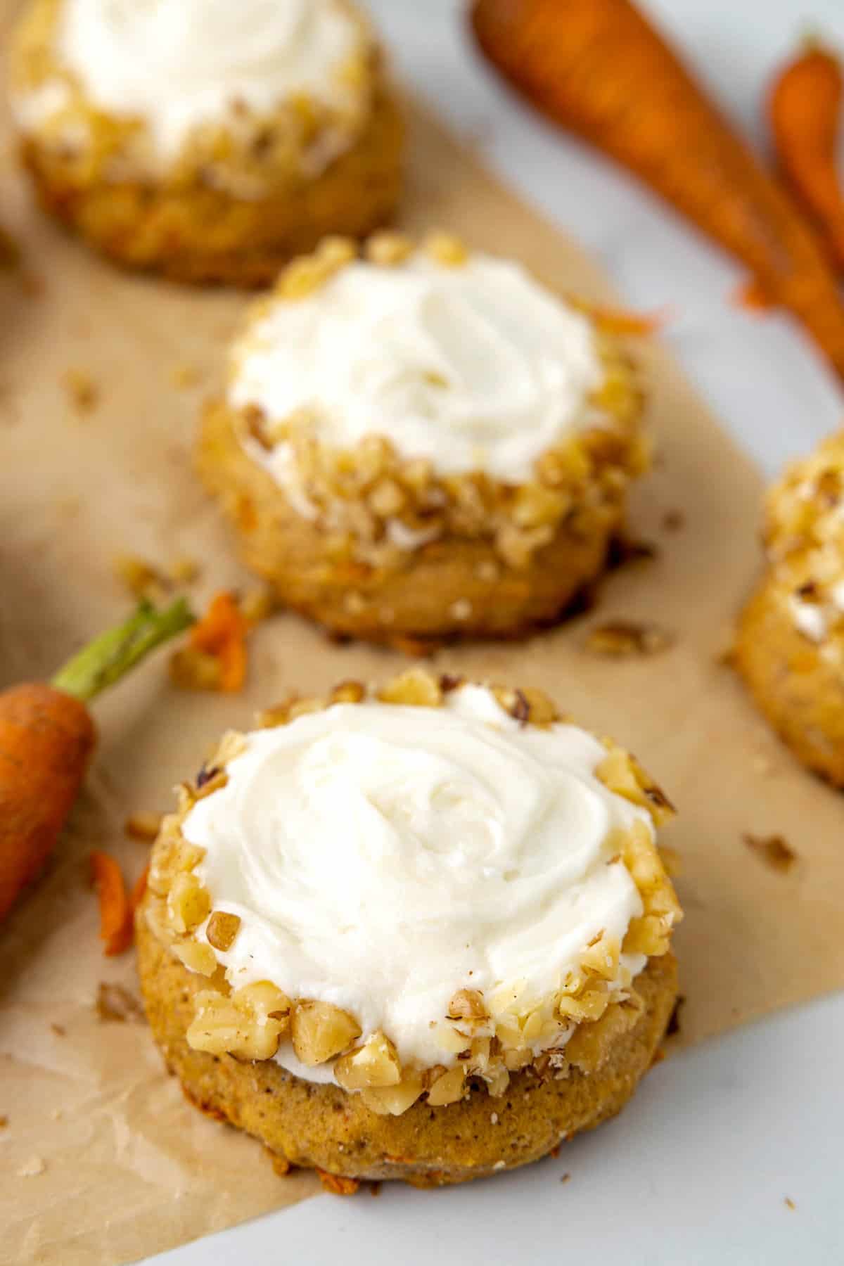 Frosted Carrot Cake Cookies on brown parchment paper