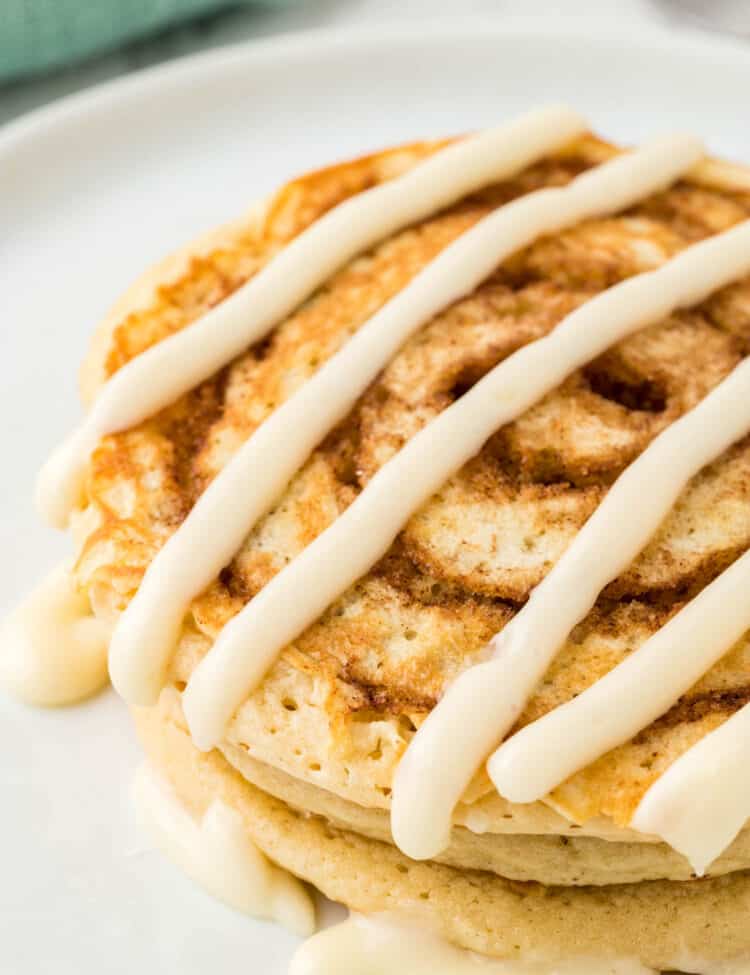 Cinnamon Swirl Pancakes on Plate Drizzled with Cream Cheese Icing