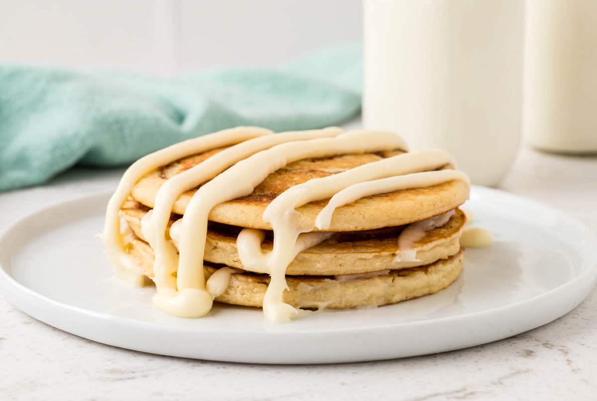 Cinnamon Swirl Pancakes on Plate Drizzled with Cream Cheese Icing