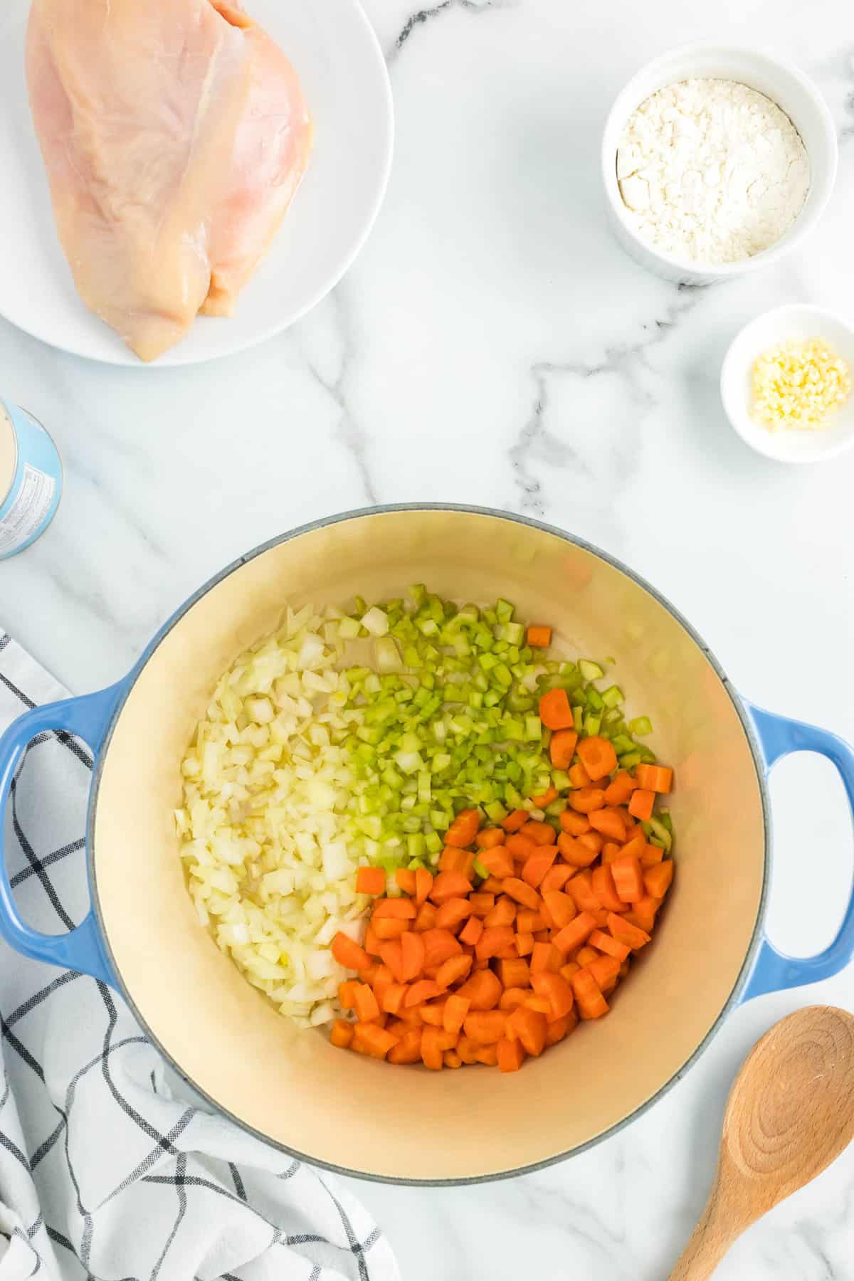 Using a Dutch Oven to Saute Vegetables in Oil for Creamy Chicken Noodle Soup