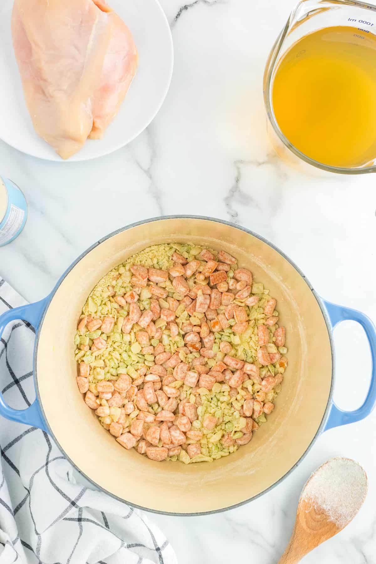 Vegetables in Dutch Oven for Creamy Chicken Noodle Soup Recipe Topped with All-Purpose Flour