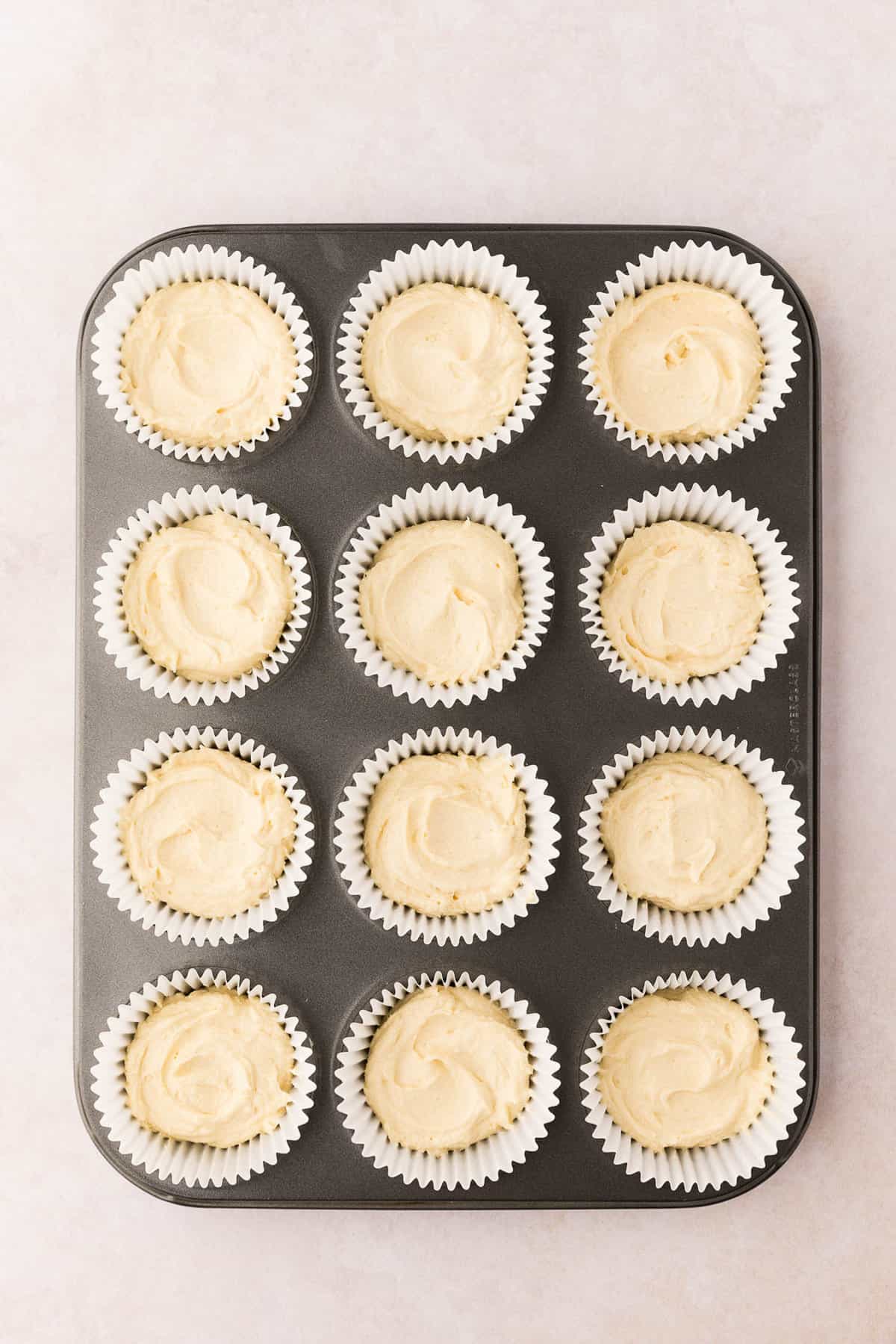 Adding Batter to Cupcake Liners in Muffin Tin for Easter Cupcakes