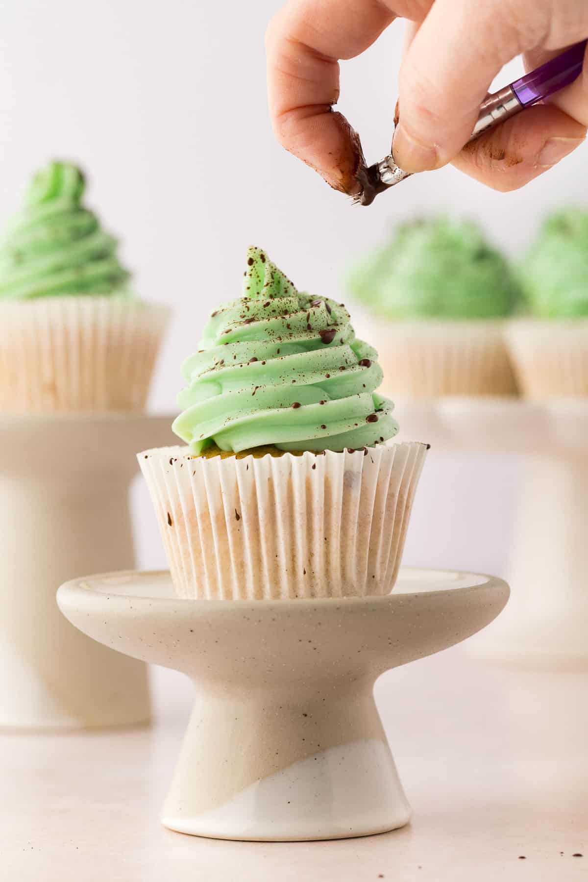 Splatting Cocoa Atop Frosting for Easter Egg Cupcakes