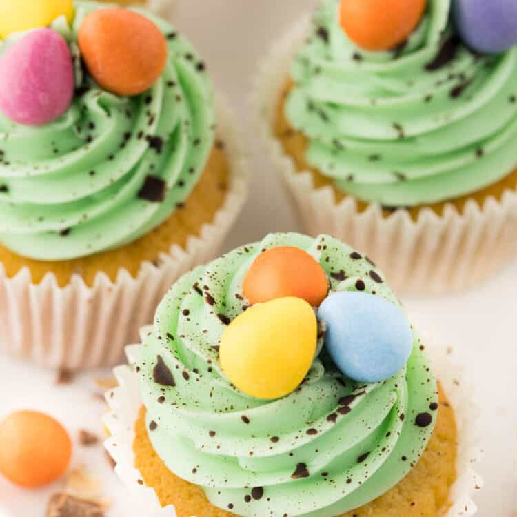 Decorated Easter cupcakes on white platter