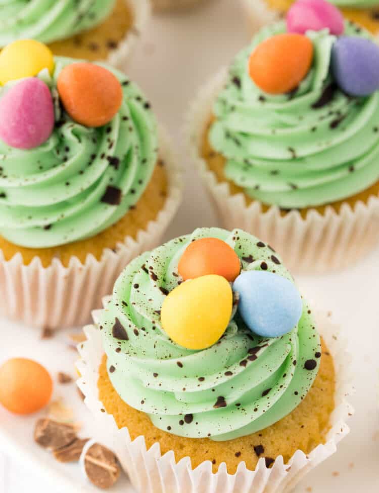 Decorated Easter cupcakes on white platter