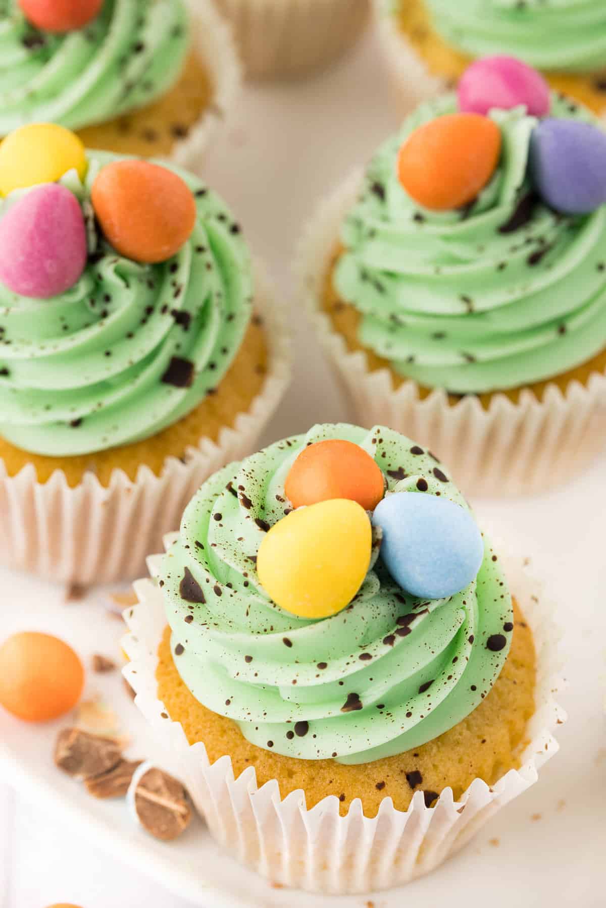 Decorated Easter cupcakes on white platter